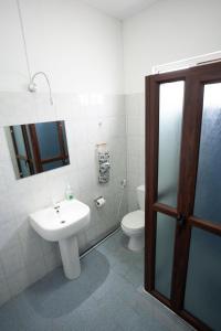 a bathroom with a sink and a toilet at Spacious Coastal Home Steps from the Beach in Flic-en-Flac
