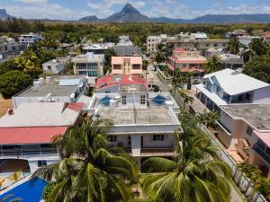 an aerial view of a city with a mountain in the background at Spacious Coastal Home Steps from the Beach in Flic-en-Flac