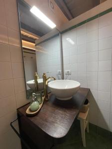 a bathroom with a sink and a mirror at Rota's House in Bergamo