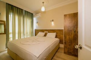 a bedroom with a large bed and a window at Cleopatra King Apart in Alanya +80 photos