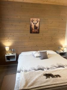 a bedroom with a bed with wooden walls at Appartamento vacanze Piazza in Fondo