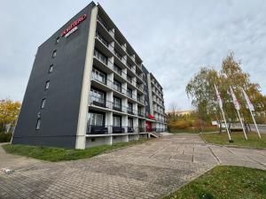 a building with a sign on the side of it at DORMERO Hotel Weimar in Weimar