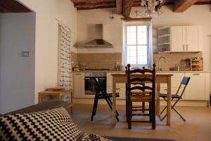 a kitchen with a table and chairs in a room at S. Agostino Fronte Mura in Lucca