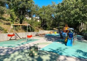 a playground with a slide and a swing at Spacieux T2 Superbe vue mer in Grimaud +21 photos