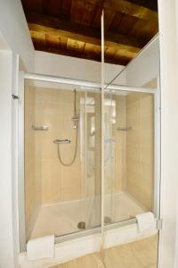 a shower with a glass door in a bathroom at Palazzo Cavalli Pasquini in Verona