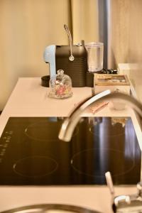 a kitchen counter with a sewing machine on top at Palazzo Cavalli Pasquini in Verona +96 photos