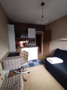 a small living room with a table and a couch at Gästezimmer im Dachgeschoss in Rhede