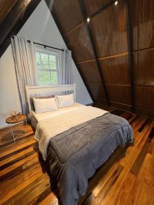 ItaquáにあるChalé de alto padrão Nereuのベッドルーム1室(屋根裏部屋に大型ベッド1台付)