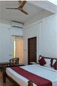 a bedroom with a large bed with a ceiling fan at Estherea Bagh Ranthambhore Tiger Territory in Sawāi Mādhopur