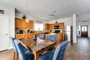 a kitchen with a dining table and blue chairs at Fabulous & Stylish 4BR w Pool Table and Space to Chill in Houston +30 photos