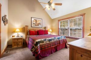 a bedroom with a bed and a ceiling fan at Creekside - 2 BDR Resort Cabin in Epic Location in Branson West