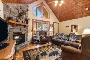 a living room with a couch and a fireplace at Creekside - 2 BDR Resort Cabin in Epic Location in Branson West