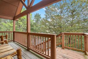 a wooden deck with a bench on it at Simon's Treetop Cabin - 2 BDR in Popular Resort in Branson West