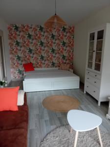 a living room with a couch and a table at Le Germini in Mirecourt