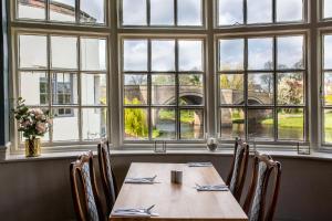 a table in a restaurant with a view of a bridge at George of Piercebridge in Piercebridge