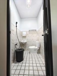 a bathroom with a toilet and a sink at PA L Residence in Euscara
