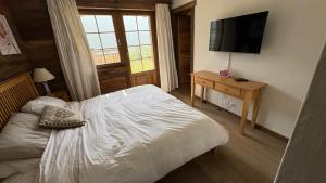 a bedroom with a bed and a flat screen tv at Jean in Grimentz