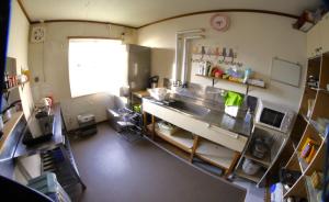 a kitchen with a counter and a sink in it at Minpakushisetsu Nipopo - Vacation STAY 19569 in Fukagawa