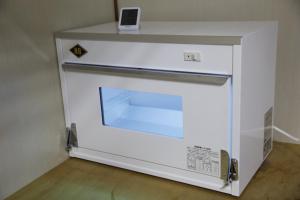 a white oven with a clock on top of it at Minpakushisetsu Nipopo - Vacation STAY 19569 in Fukagawa