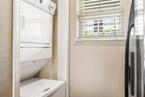 a white refrigerator in a kitchen with a window at Sunset Daydream - Elegant Condo on Table Rock in Branson