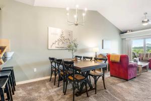 a dining room and living room with a table and chairs at Sunset Daydream - Elegant Condo on Table Rock in Branson