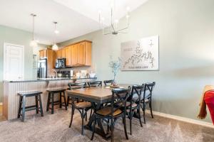 a kitchen and dining room with a table and chairs at Sunset Daydream - Elegant Condo on Table Rock in Branson +17 photos
