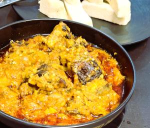 a pan full of food with some bread in it at Asato Classic Hotel in Asaba
