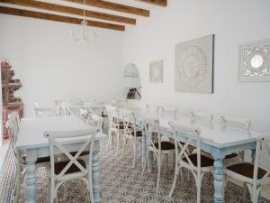 a white room with tables and chairs in it at Casa Rural El Charruado in Sanlúcar de Barrameda +53 photos