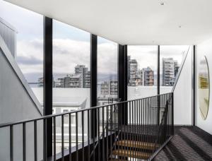 a staircase in a building with views of the city at Sand Hotel by Keahotels in Reykjavík