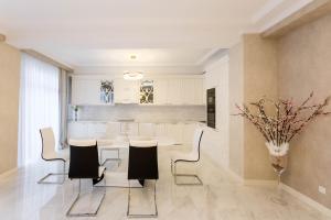 a kitchen with a table and chairs in a room at Central Elegant Apartment in Tbilisi City