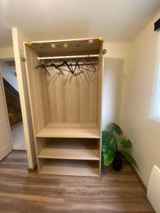 a closet in a room with a shelf at Calme et nature in Venoy