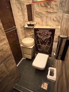 a small bathroom with a toilet and a sink at Pyramids Mystery Inn in Cairo