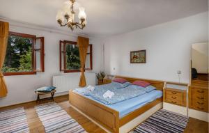 a bedroom with a bed and a chandelier at Gorgeous Home In Ravna Gora With Wifi in Ravna Gora
