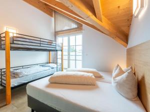 two bunk beds in a room with wooden ceilings at Luxury penthouse with Balcony, Ski Storage, Carport, Lift in Brixen im Thale