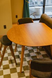 a wooden table and chairs in a room at The Shore Inn in Chatan +13 photos