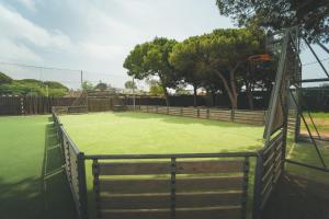 a tennis court with a net on top of it at Tres Estrellas Barcelona by HolaCamp in Gavà
