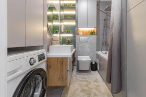 une salle de bains avec lave-linge et lavabo dans l'établissement ЖК Поколение, Байтерек, Абу Даби 434, à Astana 25 autres photos