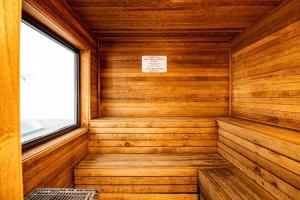 a wooden sauna with a window and a sign at Great Escape Duo in Branson