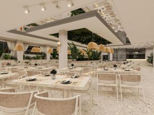 a dining room with white tables and chairs at Annabella Park Hotel - All Inclusive in Avsallar