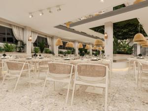 a dining room with white tables and chairs at Annabella Park Hotel - All Inclusive in Avsallar +16 photos