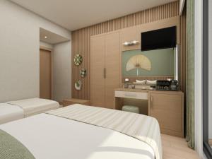 a hotel room with two beds and a television at Annabella Park Hotel - All Inclusive in Avsallar