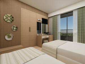 a hotel room with two beds and a bathroom at Annabella Park Hotel - All Inclusive in Avsallar