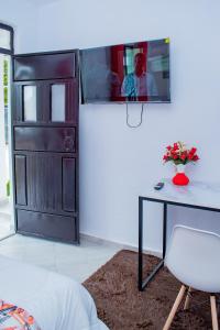 a room with a table and a door with a man at Lake View Suites, Homa Bay in Homa Bay +18 photos