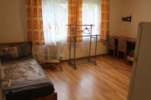 a room with a bed and a table and chairs at Bungalow 1 - 4-Raum-Wohnung mit Küche und 2 WC Duschen in Ohrdruf-Crawinkel in Ohrdruf