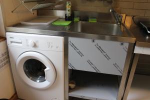 a kitchen with a sink and a washing machine at Bungalow 1 - 4-Raum-Wohnung mit Küche und 2 WC Duschen in Ohrdruf-Crawinkel in Ohrdruf