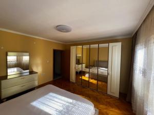 a bedroom with a bed and a large mirror at Holiday home Mitrovicë in Mitrovica