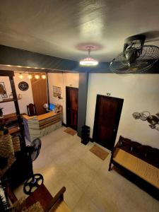 a large living room with a ceiling fan and a room with at 88 Tourist Inn by Lagum Adventure in Coron +31 photos