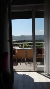 an open door to a balcony with a view at Sun Apartments in Mostar