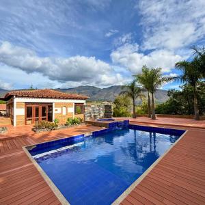 a swimming pool in front of a house at Hacienda Cascanueces in Villa de Leyva