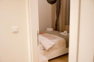 a small bedroom with a bed in a room at Bjelasnica Bliss Apartment in Bjelašnica +26 photos